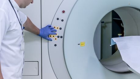 The doctor controls the magnetic resonance imaging device